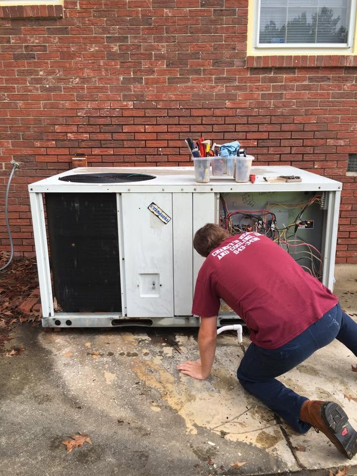 Chaney's HVAC technician servicing an outdoor air conditioner unit